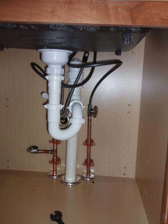 Newly installed kitchen sink drain and water lines from Docs Plumbing